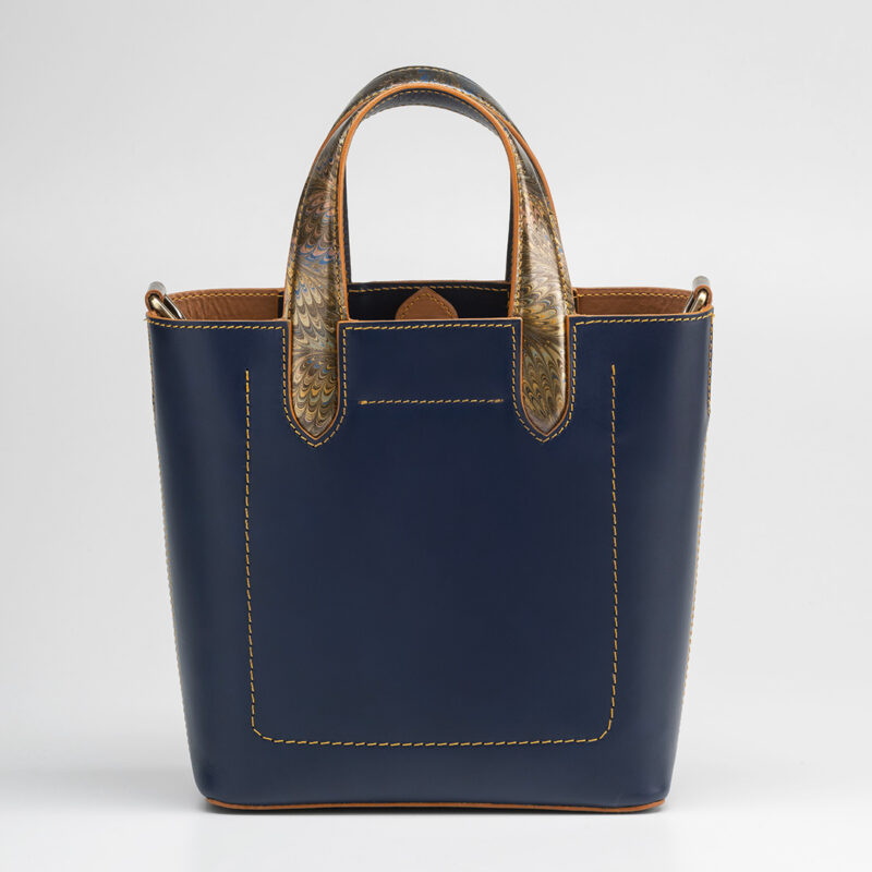 Italian vegetable tanned mini shopping bag leather from one of the most historic Tuscany tannery with light camel patent interior. Handcrafted marbeled details on the handles and the closure flap