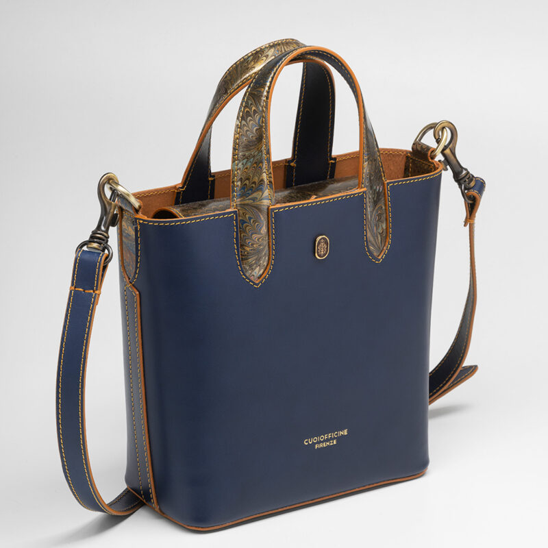Italian vegetable tanned mini shopping bag leather from one of the most historic Tuscany tannery with light camel patent interior. Handcrafted marbeled details on the handles and the closure flap