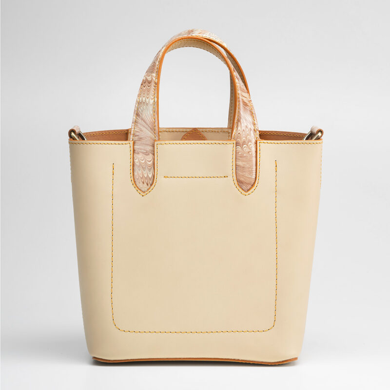 Italian vegetable tanned mini shopping bag leather from one of the most historic Tuscany tannery with light camel patent interior. Handcrafted marbeled details on the handles and the closure flap. Ivory